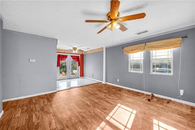 unfurnished room featuring french doors, ceiling fan, and hardwood / wood-style flooring