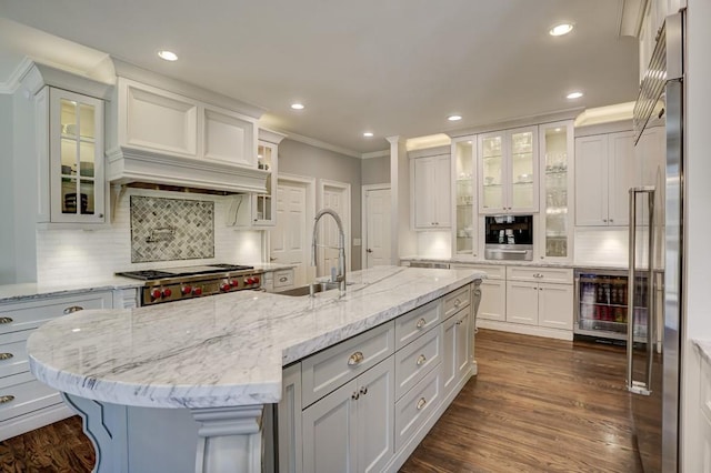 kitchen featuring backsplash, wine cooler, dark wood finished floors, white cabinetry, and a sink