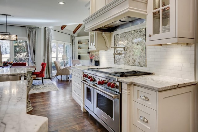 kitchen with glass insert cabinets, custom range hood, double oven range, and light stone countertops