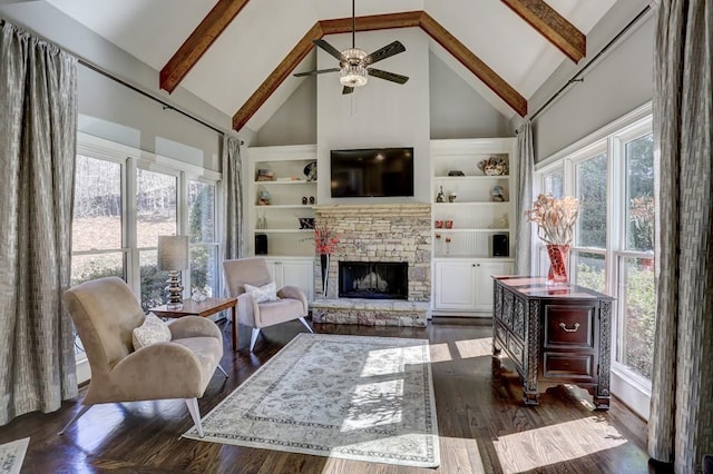 living room with beam ceiling, dark wood-style floors, built in features, and a fireplace