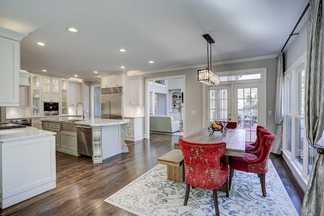 dining space with dark wood-type flooring, recessed lighting, french doors, and ornamental molding