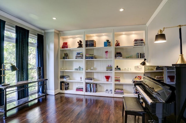 sitting room with built in shelves, wood finished floors, and ornamental molding