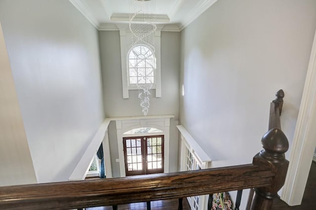 entrance foyer featuring an inviting chandelier and ornamental molding