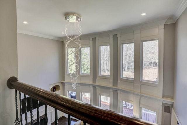 interior space featuring a chandelier, recessed lighting, and crown molding