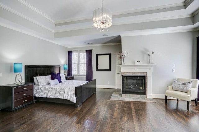 bedroom featuring a tile fireplace, baseboards, dark wood-style flooring, and ornamental molding