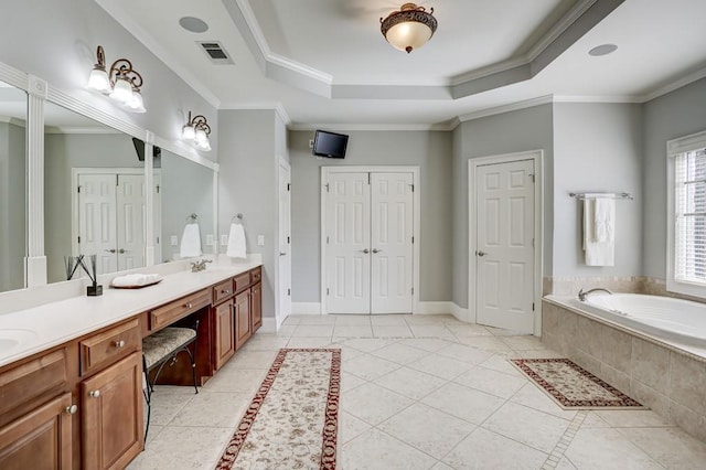 full bathroom with a tray ceiling, visible vents, baseboards, and ornamental molding