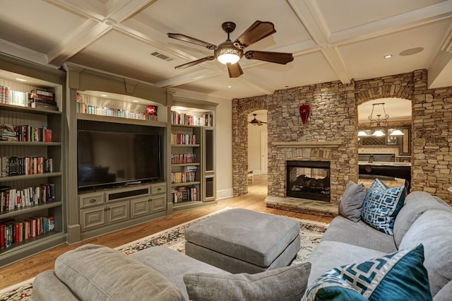 living room featuring visible vents, beam ceiling, a fireplace, wood finished floors, and coffered ceiling