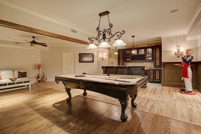 recreation room featuring light wood finished floors, wet bar, ceiling fan, pool table, and crown molding