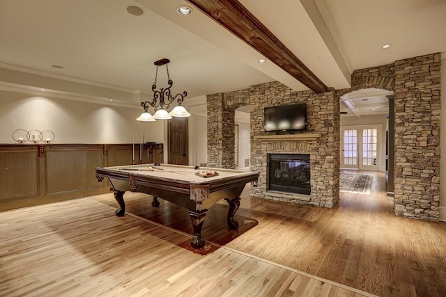 rec room featuring light wood finished floors, beamed ceiling, wainscoting, billiards, and ornate columns