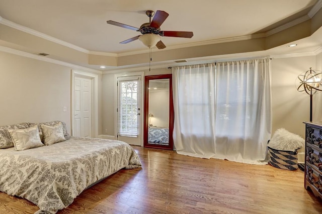 bedroom with visible vents, access to exterior, wood finished floors, crown molding, and ceiling fan