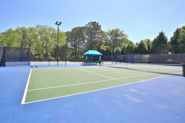 view of sport court with fence