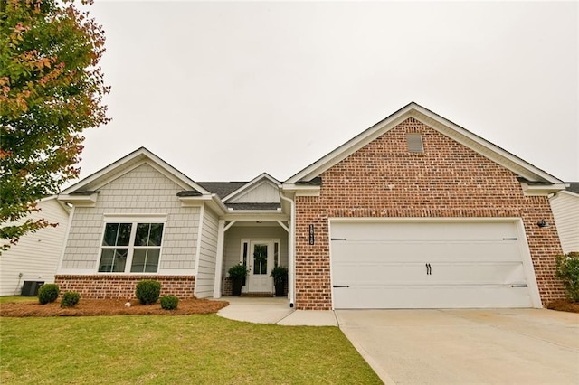view of front of house featuring brick siding, an attached garage, driveway, and a front yard