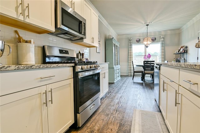 kitchen featuring stainless steel appliances, dark wood-type flooring, backsplash, crown molding, and hanging light fixtures