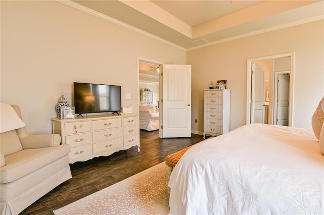 bedroom with dark wood finished floors, crown molding, and a tray ceiling