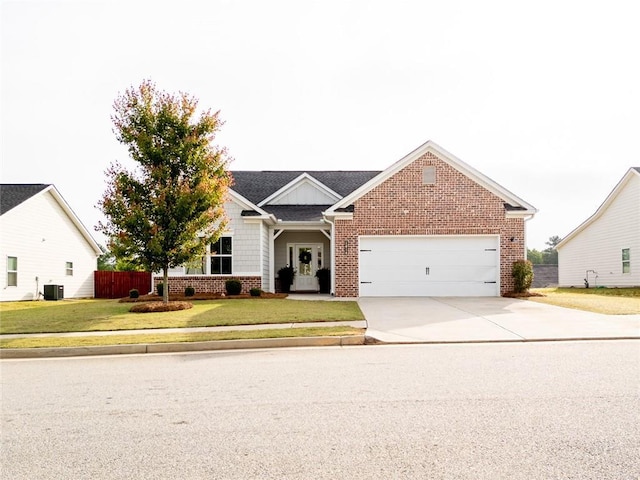 view of front of property featuring brick siding, driveway, a garage, and cooling unit