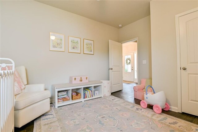 rec room featuring wood finished floors and baseboards