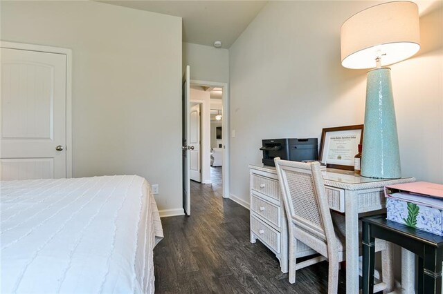 bedroom featuring dark wood finished floors, baseboards, and an office area