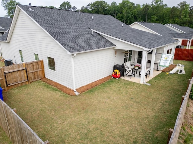 rear view of property with roof with shingles, central AC unit, a patio, and a gate