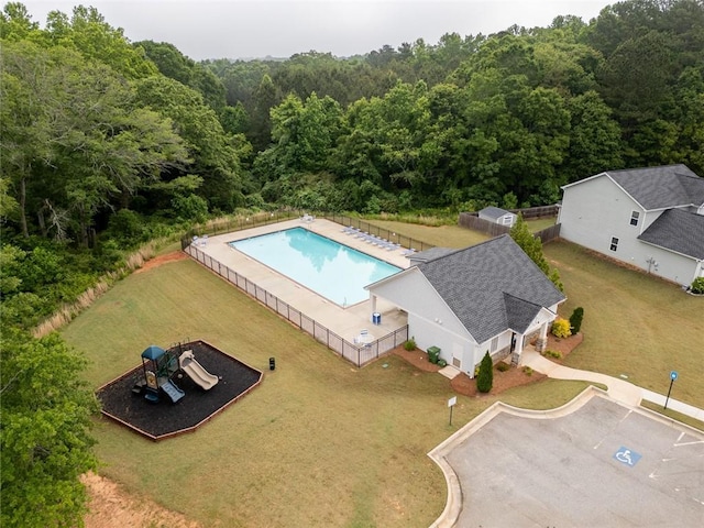 bird's eye view of a heavily wooded area and a pool area