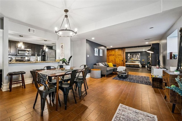 3048 Briarcliff Rd NE Unit 9, Atlanta, GA 30329 - dining room with hardwood / wood-style floors and a chandelier