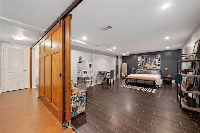 3048 Briarcliff Rd NE Unit 9, Atlanta, GA 30329 - bedroom with a barn door, wood finished floors, and recessed lighting