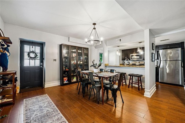 3048 Briarcliff Rd NE Unit 9, Atlanta, GA 30329 - dining room featuring a chandelier and dark wood-style flooring