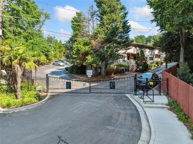 3048 Briarcliff Rd NE Unit 9, Atlanta, GA 30329 - view of asphalt road with a gate, a gated entry, and curbs