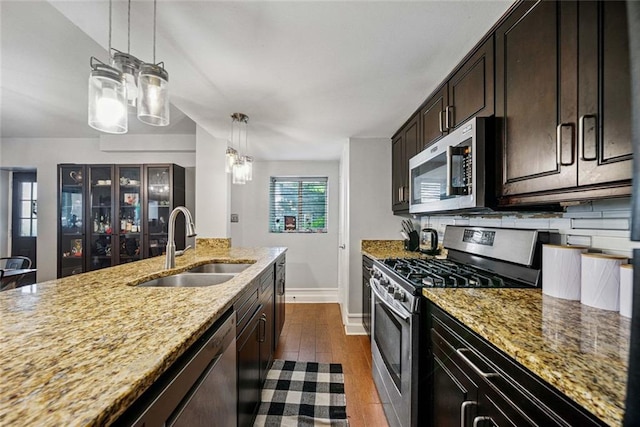 3048 Briarcliff Rd NE Unit 9, Atlanta, GA 30329 - kitchen with stainless steel appliances, a chandelier, light stone countertops, dark wood-type flooring, and pendant lighting