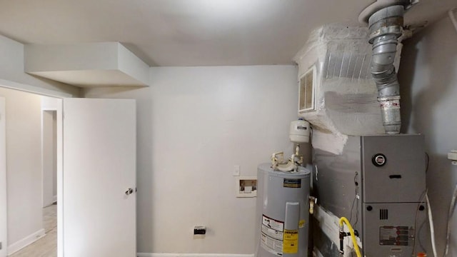 utility room featuring water heater