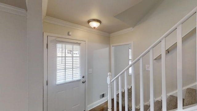 entryway featuring stairway, visible vents, and crown molding