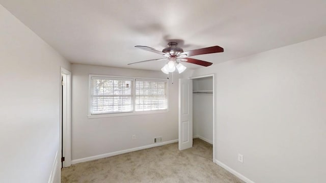 unfurnished bedroom featuring light colored carpet, ceiling fan, visible vents, and baseboards