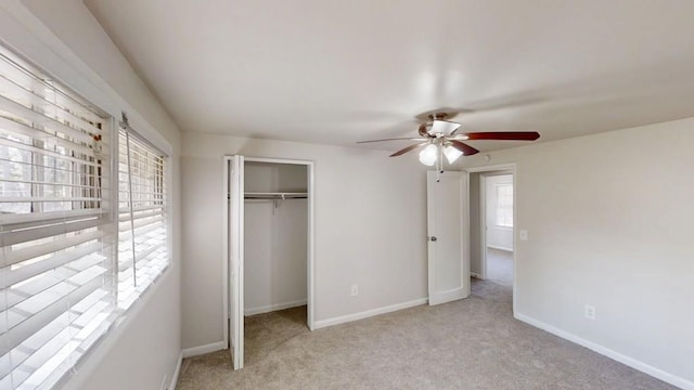 unfurnished bedroom featuring carpet floors, a closet, a ceiling fan, and baseboards