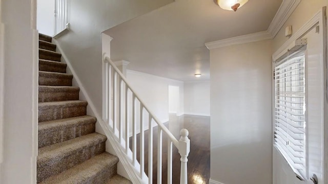 staircase featuring ornamental molding and baseboards