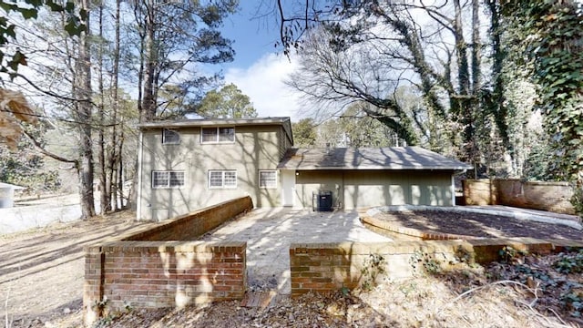 view of front of house featuring central AC unit, fence, and stucco siding