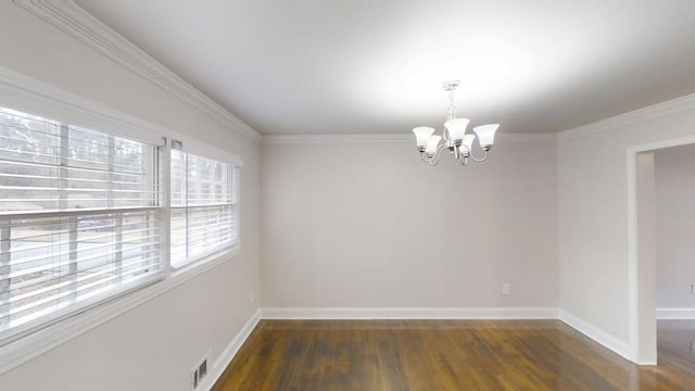 empty room with baseboards, wood finished floors, visible vents, and an inviting chandelier