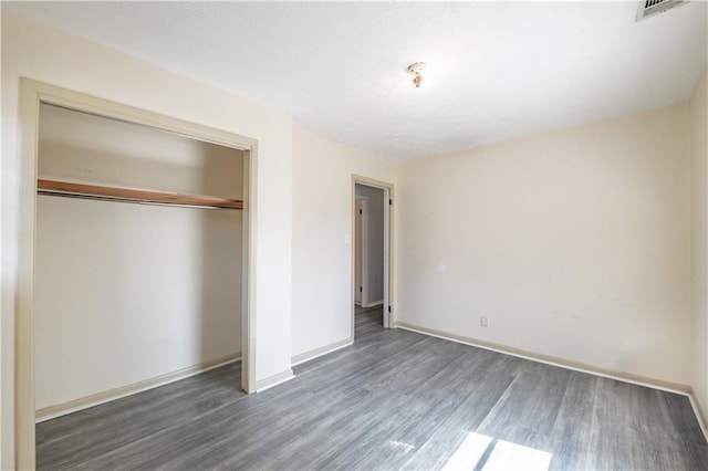 821 Charles Cir, Griffin, GA 30224 - unfurnished bedroom featuring wood finished floors, a closet, and baseboards
