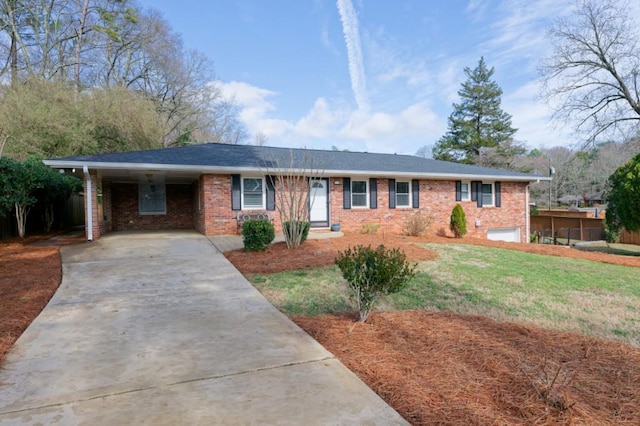 single story home featuring a carport, concrete driveway, brick siding, and a front yard