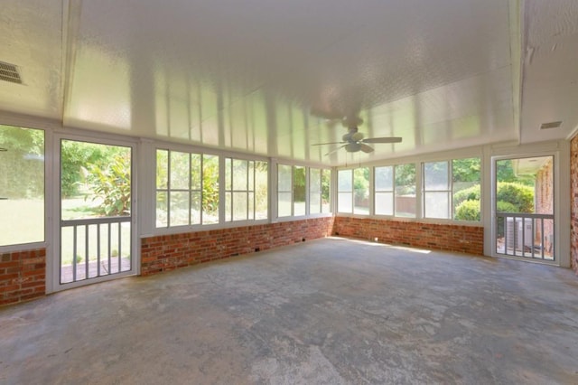 unfurnished sunroom featuring ceiling fan and visible vents