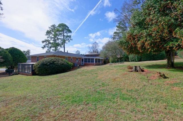 view of yard with a sunroom