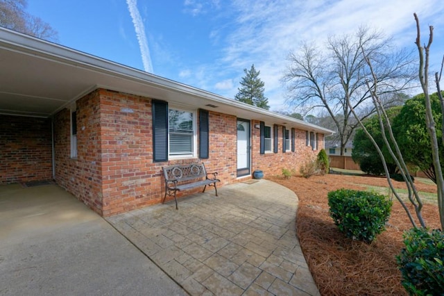 view of front facade featuring a patio area and brick siding