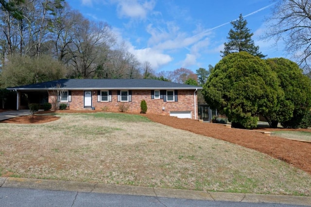 ranch-style home featuring a carport, brick siding, concrete driveway, and a front yard