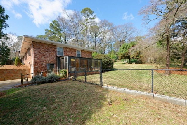 exterior space featuring a gate, fence, and a sunroom