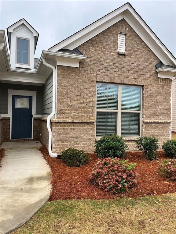 doorway to property featuring brick siding