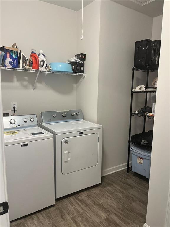 laundry room with baseboards, dark wood-style flooring, laundry area, and washer and dryer