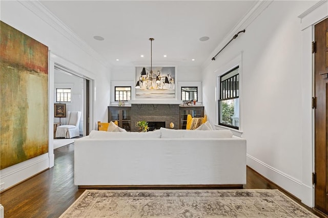 unfurnished living room with dark wood-type flooring, crown molding, a fireplace, and baseboards