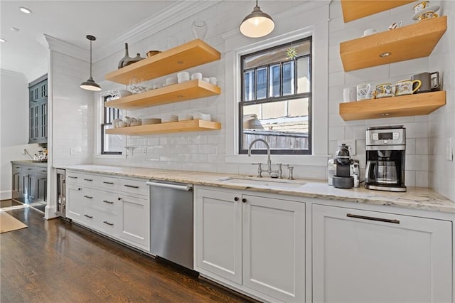 kitchen with open shelves, crown molding, dark wood-type flooring, stainless steel dishwasher, and a sink