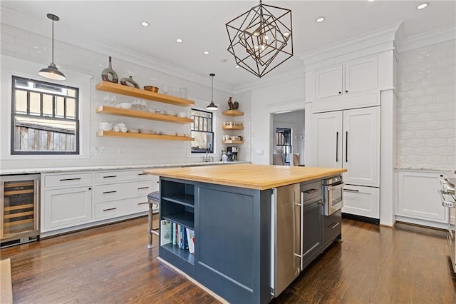 kitchen with open shelves, butcher block countertops, wine cooler, white cabinets, and crown molding