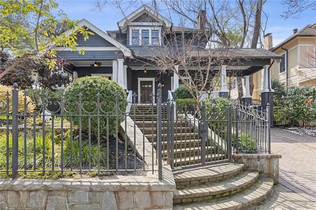 view of front of property with a porch and a shingled roof