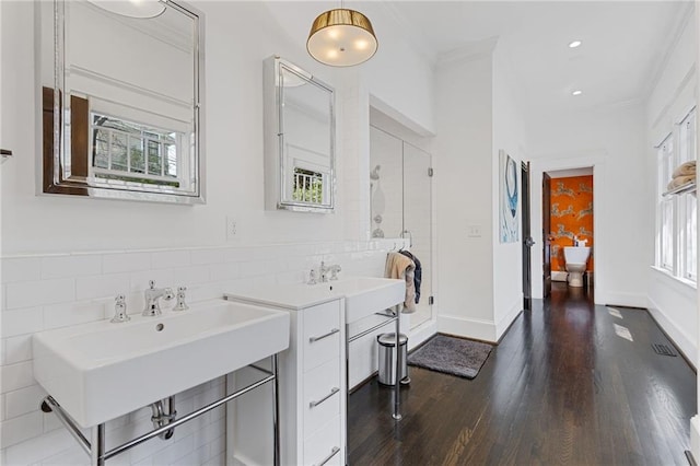 full bath featuring baseboards, wood finished floors, a stall shower, and ornamental molding