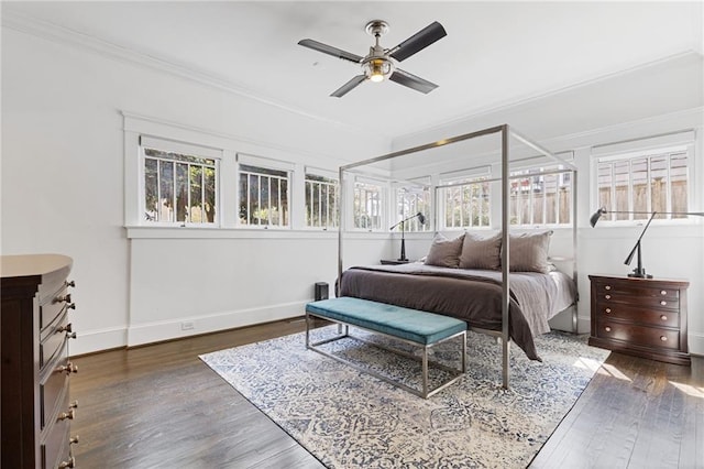 bedroom featuring baseboards, a ceiling fan, ornamental molding, and dark wood finished floors